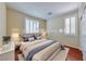 Bedroom with wood floors and natural light and shuttered windows at 5952 Long Bay St, Las Vegas, NV 89148