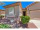 Close up exterior view of a stucco home with a well maintained garden and a window at 5952 Long Bay St, Las Vegas, NV 89148