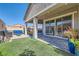 A covered back patio leads out to an artificial turf yard, providing an excellent outdoor living space at 6033 Bugsy St, North Las Vegas, NV 89081