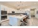 Modern kitchen with stainless steel appliances, white cabinetry, and a large center island at 6033 Bugsy St, North Las Vegas, NV 89081