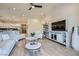 Bright, open-concept living room with hardwood floors, modern furniture, adjacent to a well-equipped kitchen at 6033 Bugsy St, North Las Vegas, NV 89081