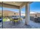 Covered patio with sleek ceiling fan includes outdoor furniture and fireplace at 6033 Bugsy St, North Las Vegas, NV 89081