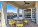 Covered patio with sleek ceiling fan includes elegant outdoor furniture for entertaining guests at 6033 Bugsy St, North Las Vegas, NV 89081