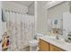 This full bathroom features a vanity with a sink and a shower with a floral curtain at 6144 Corbin Ave, Las Vegas, NV 89122