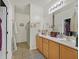 This full bathroom features a large vanity, tiled floors, and a shower with glass doors at 6144 Corbin Ave, Las Vegas, NV 89122