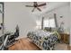 This bedroom features hardwood floors, a ceiling fan, and bright natural lighting at 6144 Corbin Ave, Las Vegas, NV 89122