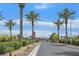 Community entry gate featuring lush landscaping and visitor parking at 6144 Corbin Ave, Las Vegas, NV 89122