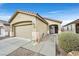 Inviting single-story home with an attached two-car garage, desert landscaping, and a cozy front porch at 6144 Corbin Ave, Las Vegas, NV 89122