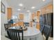 A bright eat-in kitchen features tan cabinetry, recessed lighting, and a matching kitchen table set at 6144 Corbin Ave, Las Vegas, NV 89122