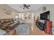 Open-concept living area with wood-look flooring, a ceiling fan, and views into the adjacent kitchen area at 6144 Corbin Ave, Las Vegas, NV 89122