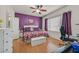 This main bedroom features hardwood floors, a ceiling fan, and an attached ensuite at 6144 Corbin Ave, Las Vegas, NV 89122