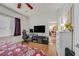 This bedroom features hardwood floors, a ceiling fan, and bright natural lighting at 6144 Corbin Ave, Las Vegas, NV 89122