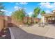 A backyard with a covered patio, barbecue grill, and a rock ground cover at 6733 Fast Brook Ct, North Las Vegas, NV 89084