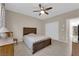 Well-lit bedroom featuring tile flooring, ceiling fan, and a window with natural light. Also features a closet and closet doors at 6733 Fast Brook Ct, North Las Vegas, NV 89084