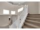 Carpeted staircase with white railing leading to the second floor, with natural light at 6733 Fast Brook Ct, North Las Vegas, NV 89084