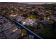 Night aerial showcases a beautiful neighborhood with tree coverage, a pool, and a basketball court at 68 Isleworth Dr, Henderson, NV 89052