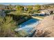 Aerial view of a private outdoor basketball court surrounded by lush landscaping at 68 Isleworth Dr, Henderson, NV 89052