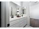 Well-lit bathroom with a double vanity, black fixtures and a neutral decor at 68 Isleworth Dr, Henderson, NV 89052