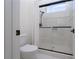 Modern bathroom featuring a glass shower and a white toilet for convenience at 68 Isleworth Dr, Henderson, NV 89052