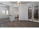 Spacious bedroom with mirrored closet doors, wood floors and natural light at 68 Isleworth Dr, Henderson, NV 89052