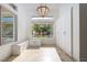 Bright bonus room with custom cabinetry, bench seating, and a large window overlooking lush landscaping at 68 Isleworth Dr, Henderson, NV 89052