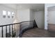 Hallway with wood floors, chandelier and a curved railing for added luxury at 68 Isleworth Dr, Henderson, NV 89052