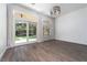 Living room featuring wood floors, light fixture, backyard access and large windows with natural light at 68 Isleworth Dr, Henderson, NV 89052