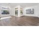 Bright living room with hardwood floors, a modern chandelier, and large windows at 68 Isleworth Dr, Henderson, NV 89052