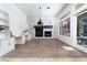 Open-concept living room features stone accent wall, modern fireplace, built-in shelves, and lots of light at 68 Isleworth Dr, Henderson, NV 89052