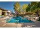 Relaxing backyard pool featuring a water feature, with a spa, and mature landscaping at 68 Isleworth Dr, Henderson, NV 89052