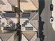 Aerial view of rooftops featuring solar panels and a street with parked cars, showcasing modern living at 6855 Evening Orchid St, North Las Vegas, NV 89086