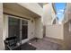 A small backyard area with stone pavers and a privacy fence at 6855 Evening Orchid St, North Las Vegas, NV 89086