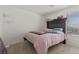 Neutral colored bedroom with a window, carpeted floor, and comfortable looking bed at 6855 Evening Orchid St, North Las Vegas, NV 89086