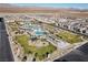 Panoramic aerial shot of a community with a pool, playground, and green spaces at 6855 Evening Orchid St, North Las Vegas, NV 89086