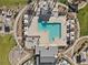 Aerial image of a community pool with a unique layout, including a hot tub and covered seating areas at 6855 Evening Orchid St, North Las Vegas, NV 89086