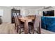 Spacious dining room featuring wood table with chairs, adjacent to the living area at 6855 Evening Orchid St, North Las Vegas, NV 89086