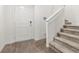 Bright entryway featuring stylish flooring, a modern security system, and a staircase at 6855 Evening Orchid St, North Las Vegas, NV 89086