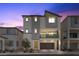 Charming two-story home featuring a modern design and a welcoming, covered balcony at 6855 Evening Orchid St, North Las Vegas, NV 89086