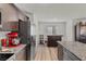 Modern kitchen featuring granite counters, wood cabinets, and stainless steel appliances at 6855 Evening Orchid St, North Las Vegas, NV 89086