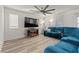 Cozy living room featuring recessed lighting, a modern fireplace, and a comfortable sectional sofa at 6855 Evening Orchid St, North Las Vegas, NV 89086