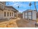 Backyard with a white shed and patio cover featuring palm trees and a blue sky at 700 Northstar St, Las Vegas, NV 89107