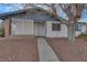 Home entrance with covered lattice porch, concrete walkway, and low maintenance yard at 700 Northstar St, Las Vegas, NV 89107