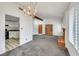 Open-concept living room with adjacent kitchen, brick fireplace, and classic built-in shelving at 700 Northstar St, Las Vegas, NV 89107