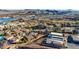 Stunning aerial view of a desert community, showing homes, a lake, and mountain views at 8 Reverie Heights Ave, Henderson, NV 89011