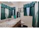 Cozy bathroom with a granite counter, matching curtains, and a neutral color scheme at 8 Reverie Heights Ave, Henderson, NV 89011