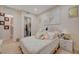 Cozy bedroom with a well-dressed queen bed, a view into the laundry room, and soft decor, offering a peaceful retreat at 8 Reverie Heights Ave, Henderson, NV 89011