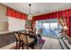 This dining area boasts a dark wood table, modern light fixture, and seamless access to the outdoor patio at 8 Reverie Heights Ave, Henderson, NV 89011