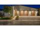 Striking home exterior showcasing a modern design, stone accents, and a three-car garage at 8 Reverie Heights Ave, Henderson, NV 89011