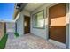 Charming front entrance featuring a brick-paved patio, a gray accent wall, and a stylish metal gate for added security and curb appeal at 8 Reverie Heights Ave, Henderson, NV 89011