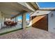 A covered outdoor living space connects the garage to the main house with a large paver driveway at 8 Reverie Heights Ave, Henderson, NV 89011